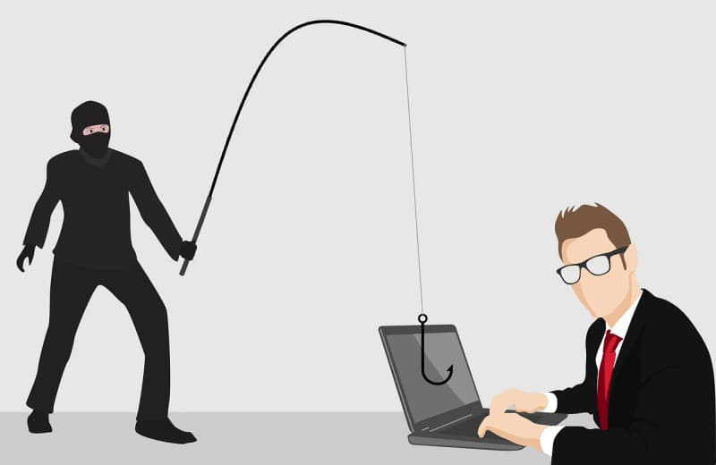Illustrazione di un cybercriminale che pesca con una canna il laptop di un uomo in giacca e cravatta, a simboleggiare un attacco di phishing